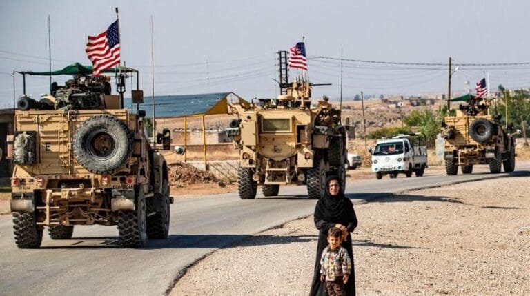 a_convoy_of_us_armored_vehicles_patrols_the_northeastern_syrian_town_of_qahtaniyah_at_the_border_with_turkey._getty_images.jpg